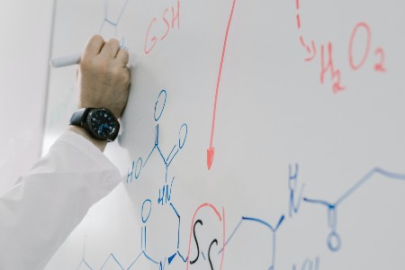 photo of the teacher writing on the blackboard